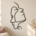 Deux visages en trait continu, décoration murale en métal noir