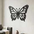 Papillon aux ailes ajourées en métal noir, déco murale